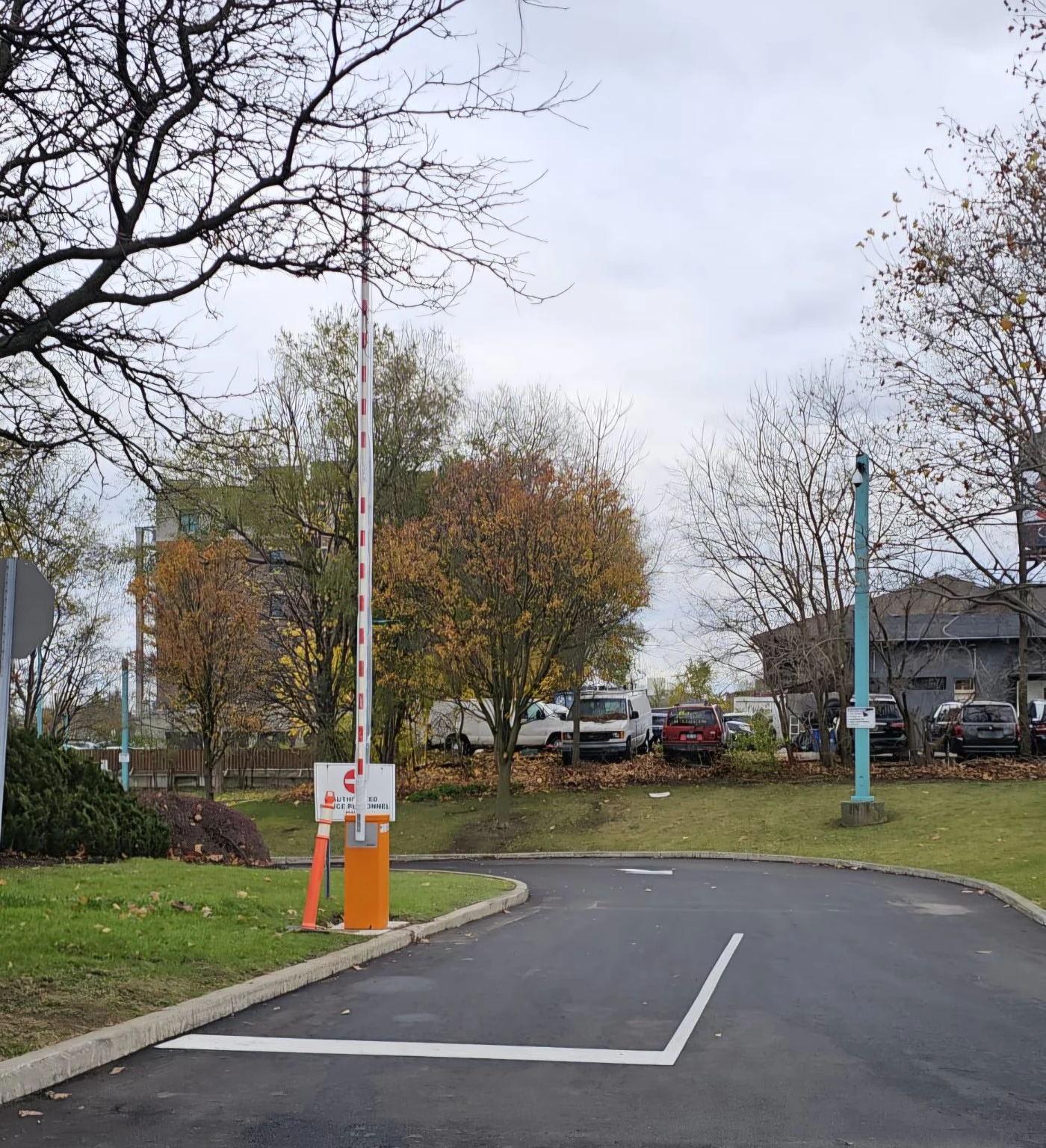 Automatic barrier gate operator controlling a paved vehicle entrance