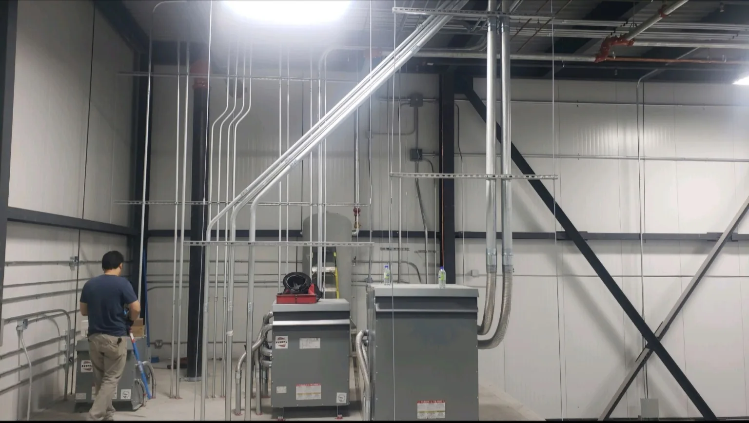 Commercial electrical conduit installation at high ceiling